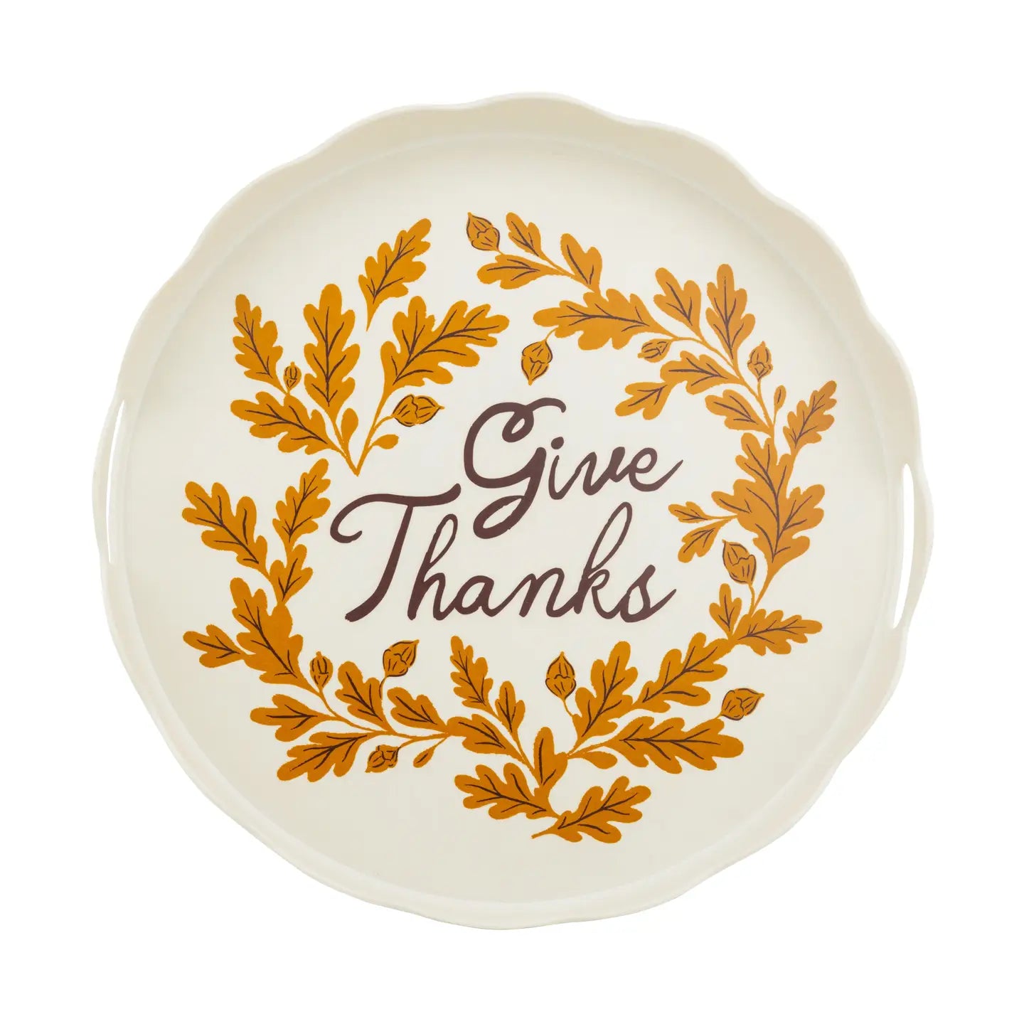 An off-white ceramic platter with a scalloped rim, featuring a golden-brown leaf wreath and the words 'Give Thanks' in dark brown script in the center, set against a plain white background.