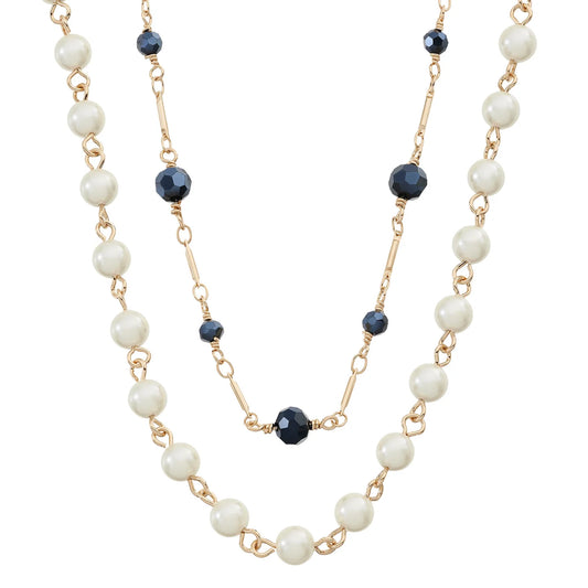A double-strand necklace featuring white faux pearl beads and gold-tone chain links, accented with faceted dark blue beads.