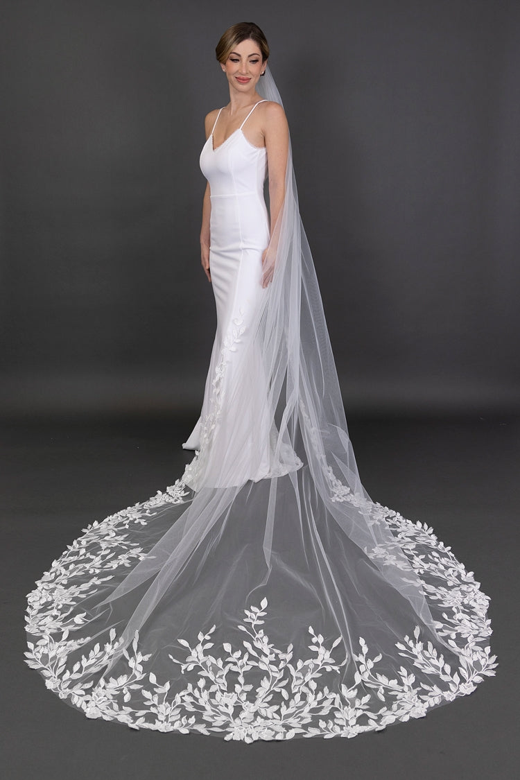White wedding dress with a long, elegant veil on a dark background