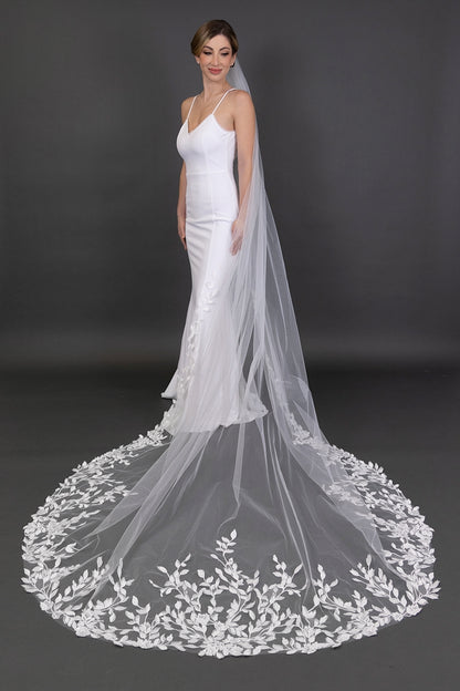 White wedding dress with a long, elegant veil on a dark background