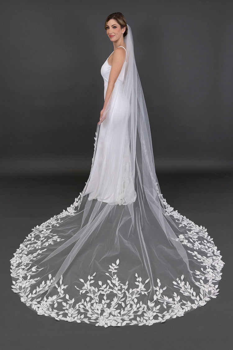 Bridal gown with a long, elegant veil on a dark background
