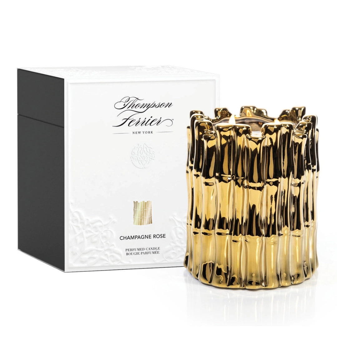 Gold candle with packaging on a white background