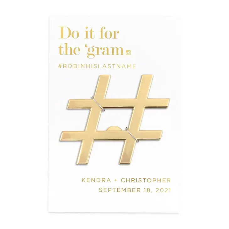 Gold hashtag charm with text on a white background