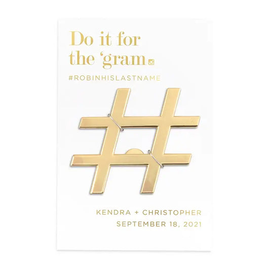 Gold hashtag charm with text on a white background
