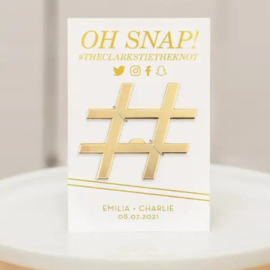 Card with gold '#' symbol and text on a white stand against a neutral background