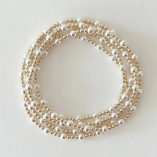 Multiple pearl necklaces of different lengths on a light background