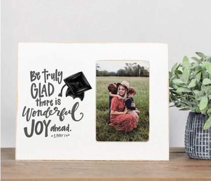Decorative sign with motivational quote and photo of a family in a field