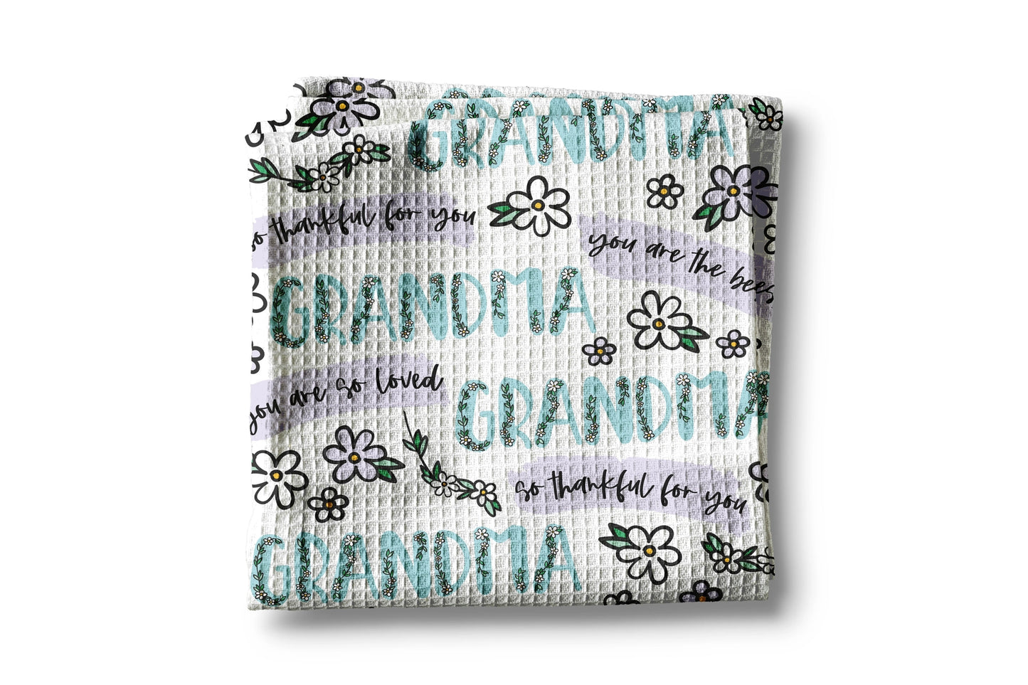 Woven blanket with 'Grandma' and floral patterns on a white background