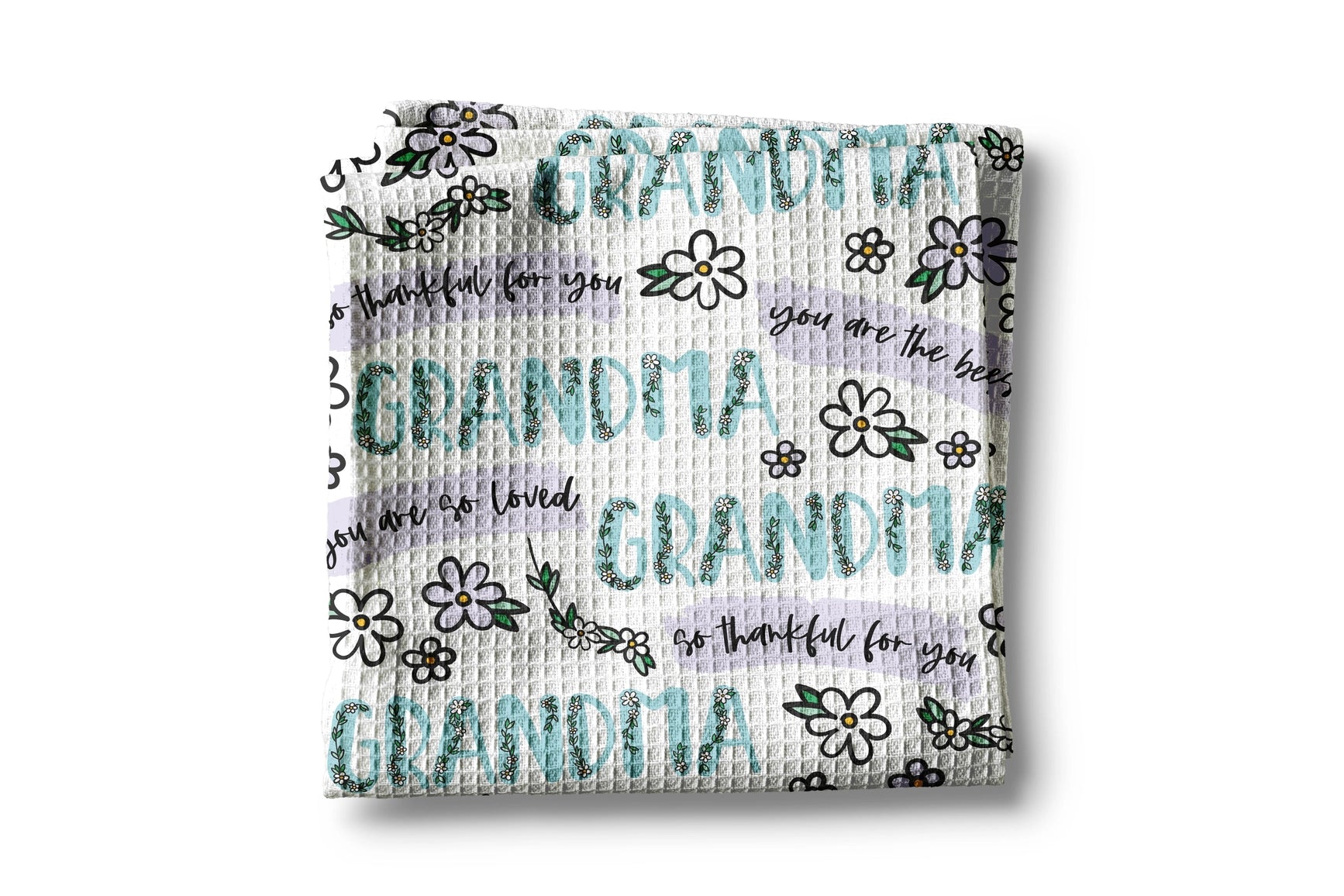 Woven blanket with 'Grandma' and floral patterns on a white background
