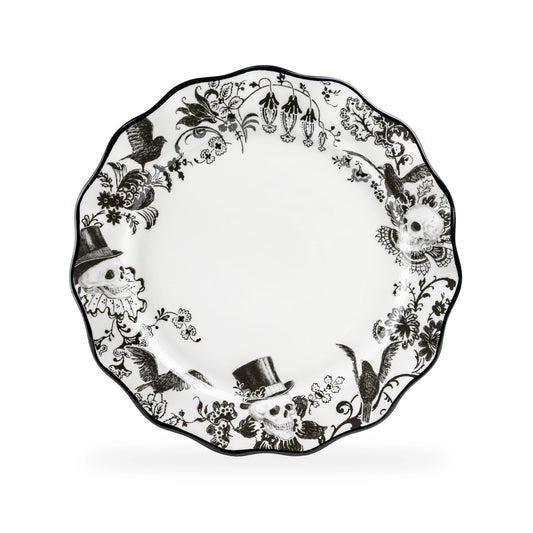 Decorative plate with black floral and bird pattern on a white background