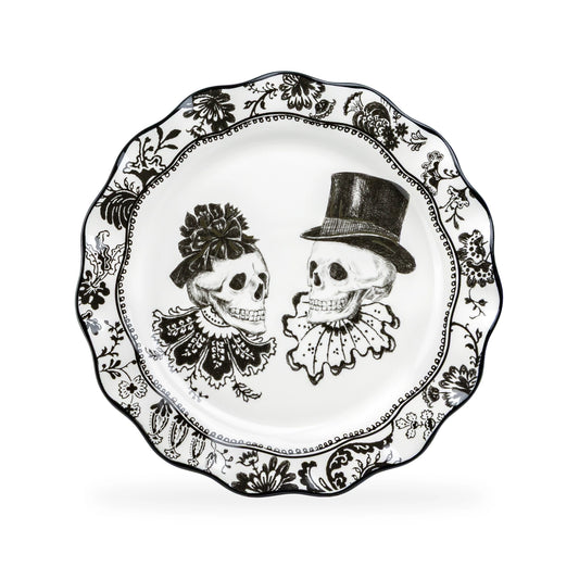 Decorative plate with black and white skull designs wearing hats on a white background