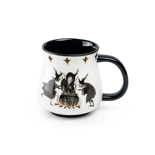 Mug with black interior, white exterior featuring a design of a witch and cat, on a white background.