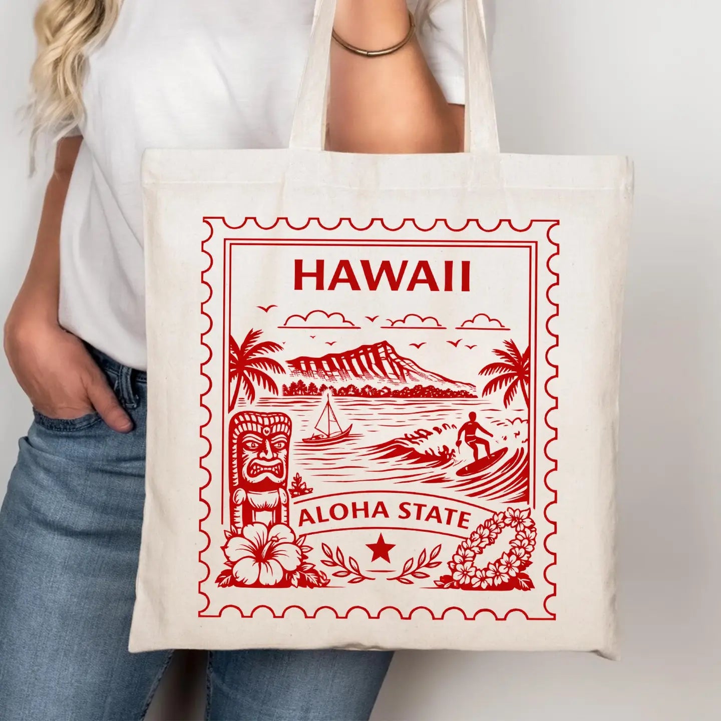 Tote bag with red Hawaii-themed design held by a person wearing a white shirt and blue jeans.