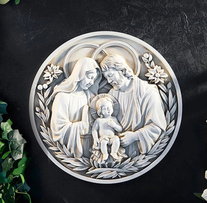 Decorative wall art of the Holy Family with floral elements on a dark background
