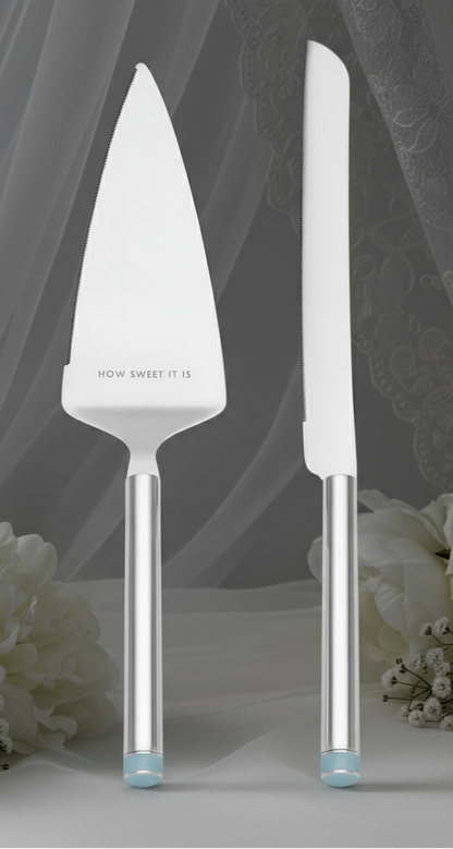 Set of cake server and knife with 'How Sweet It Is' branding on a white background