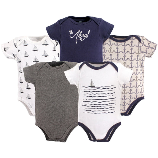 Set of baby bodysuits with nautical patterns on a white background