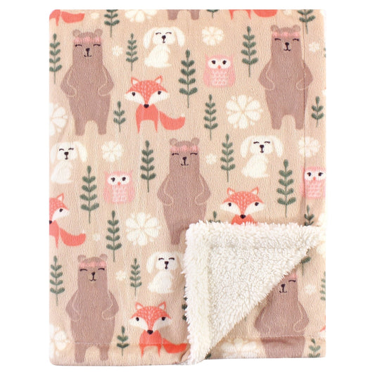 Blanket with animal pattern featuring bears, foxes, and owls on a beige background.