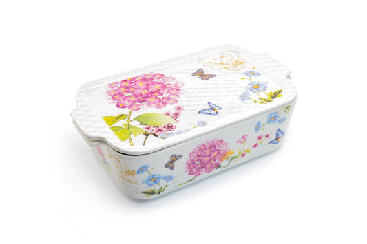Rectangular ceramic baking dish with floral and butterfly design on a white background
