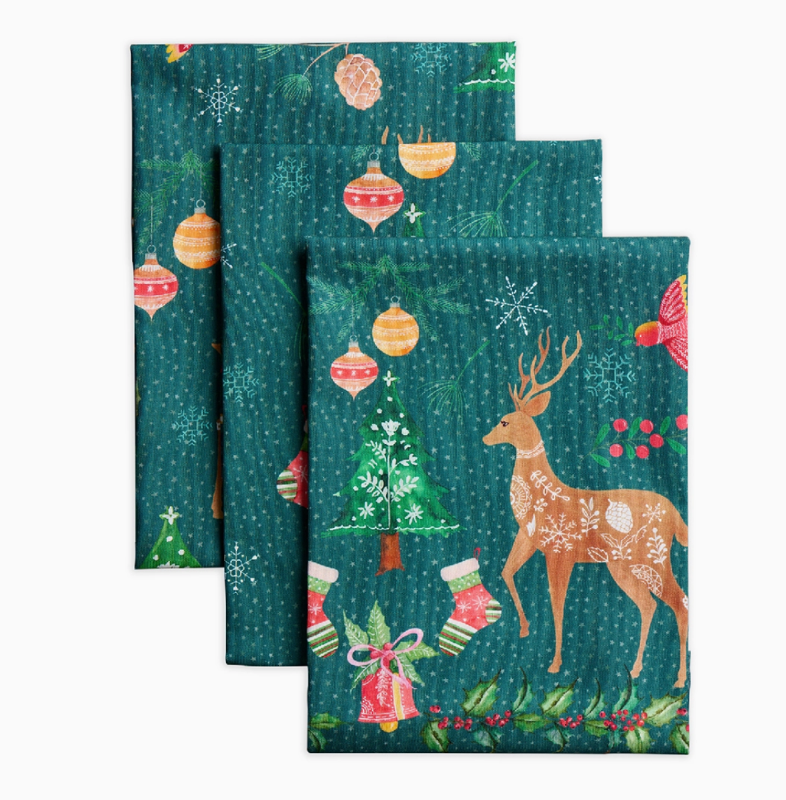 Set of three Christmas-themed napkins with reindeer, trees, and ornaments on a green background.
