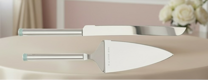 Two silver cake knives on a light background