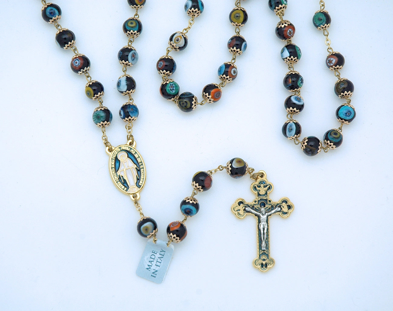 Rosary with blue and gold beads and a cross on a white background