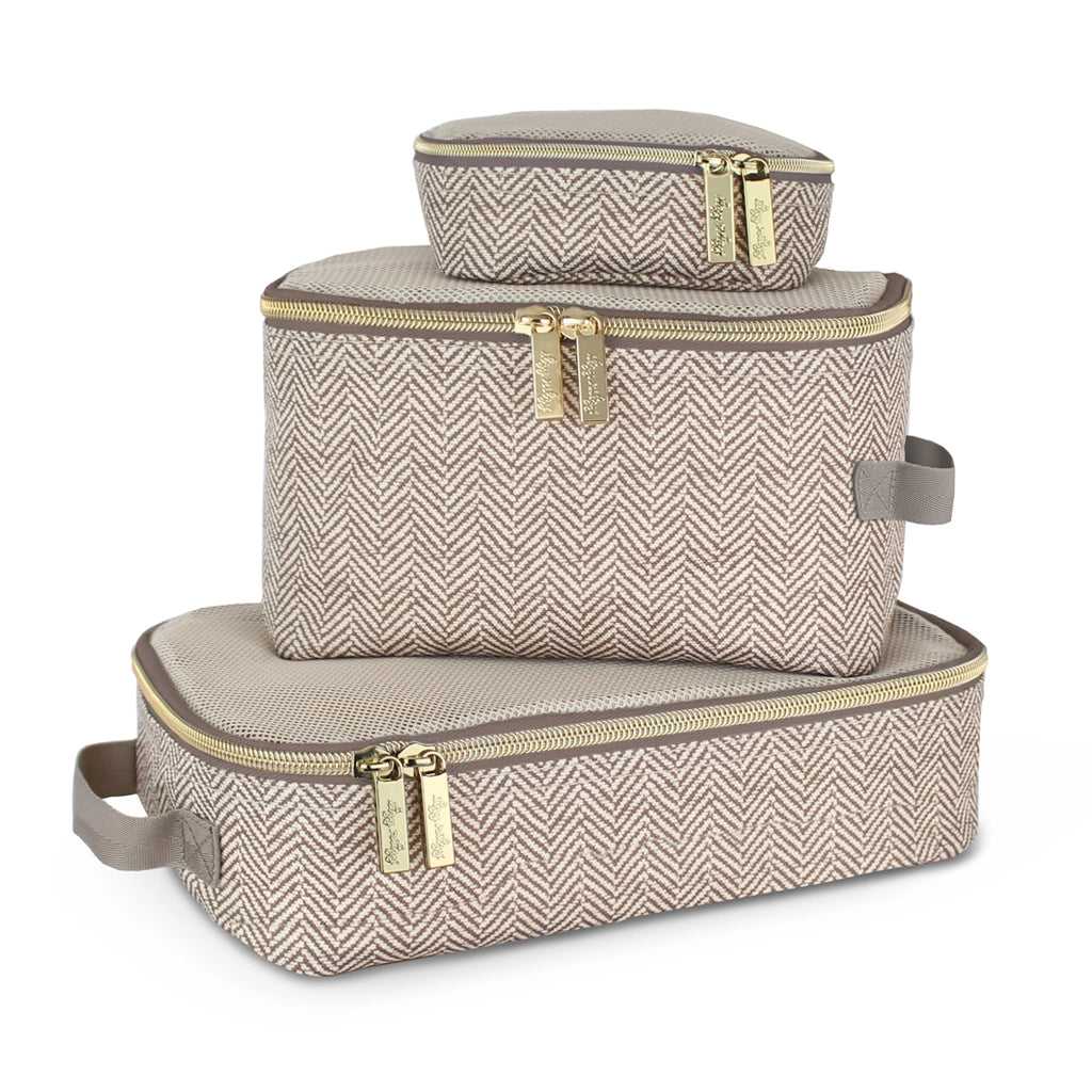 Set of three beige herringbone-patterned luggage bags with gold zippers on a white background