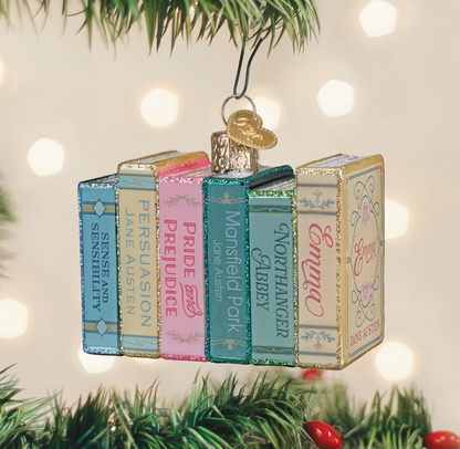 Jane Austen books glass Christmas ornament with colorful stacked classic novels hanging on a Christmas tree