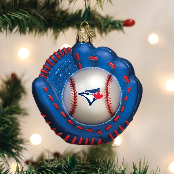 Baseball glove ornament with a baseball inside, featuring a logo, on a Christmas tree.