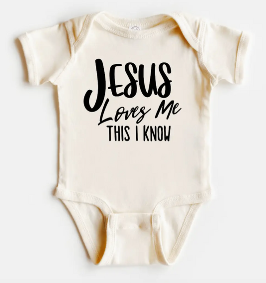 Beige baby onesie with 'Jesus Loves Me This I Know' text on a white background