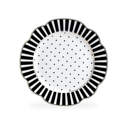 Decorative plate with black and white striped rim and polka dot center on a white background