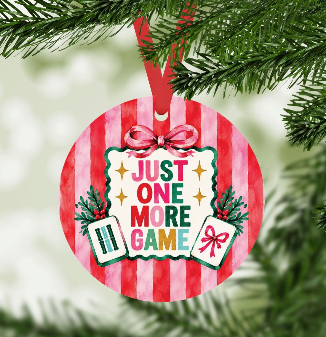 Just One More Game Mahjong ornament hanging on Christmas tree with red ribbon