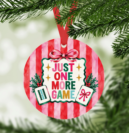 Just One More Game Mahjong ornament hanging on Christmas tree with red ribbon