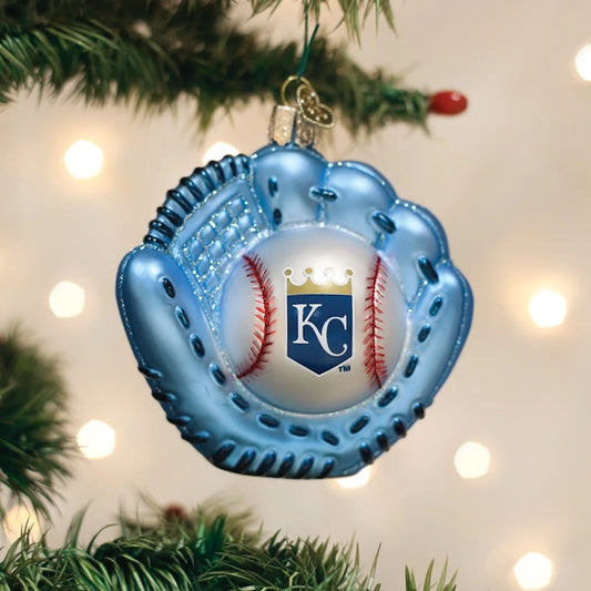 Blue baseball glove ornament with a baseball inside, featuring the 'KC' logo, hanging on a Christmas tree.