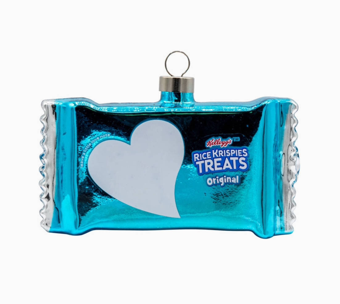 A decorative Christmas ornament shaped like a Kellogg's Rice Krispies Treat bar, featuring a metallic blue and silver wrapper design with a white heart-shaped cutout and a hanging loop at the top.