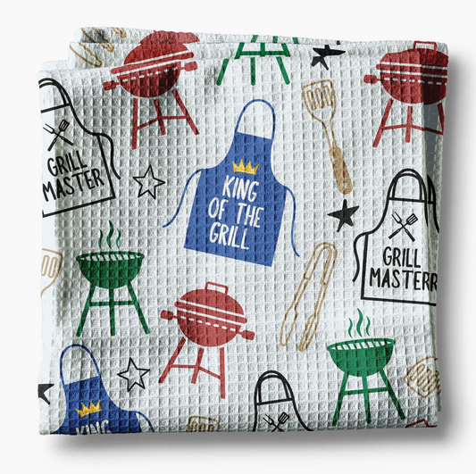 Waffle-textured towel with grill-themed designs on a white background