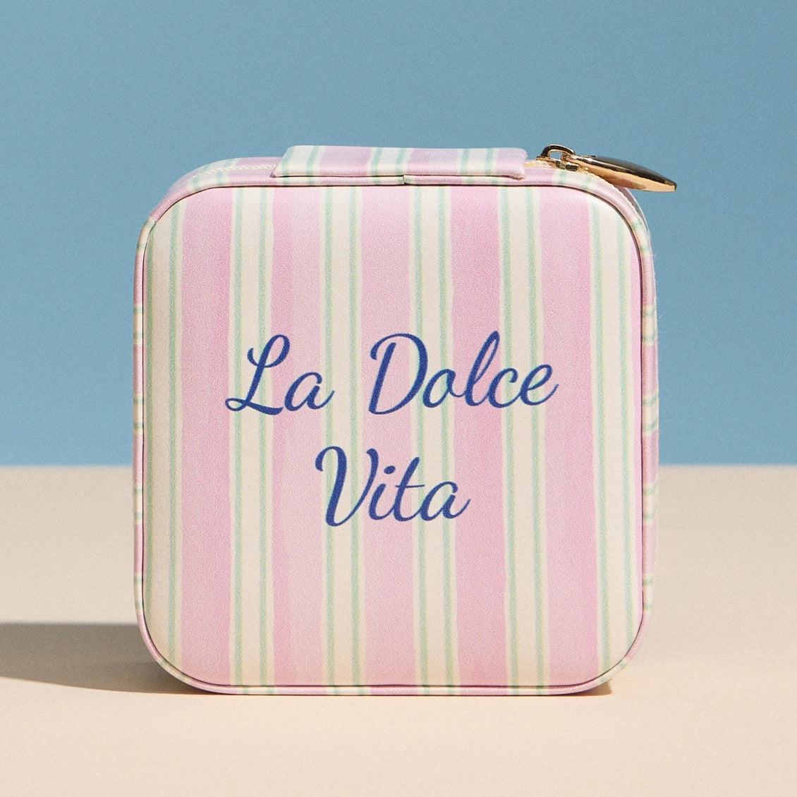 Striped case with 'La Dolce Vita' text on a blue and beige background