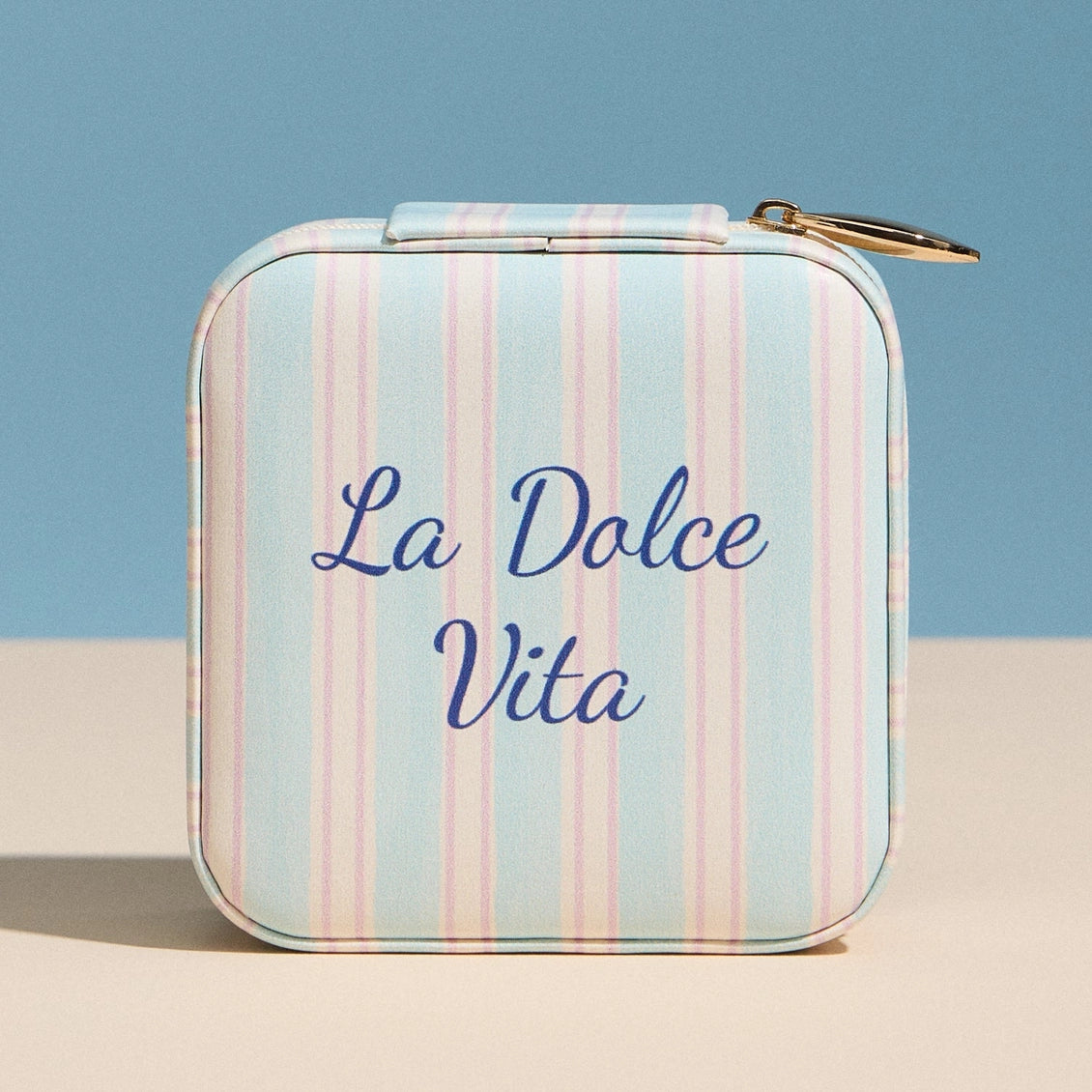 Striped case with 'La Dolce Vita' text on a blue and beige background