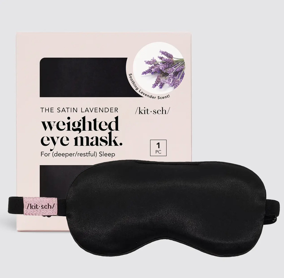 Black weighted eye mask with packaging on a light gray background