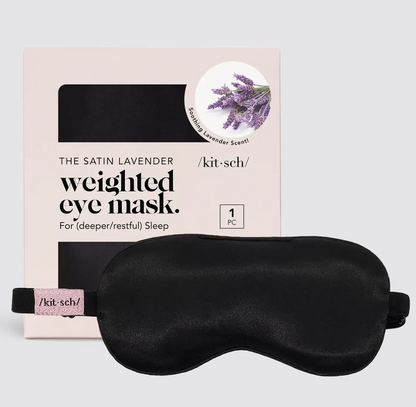 Black weighted eye mask with packaging on a light gray background