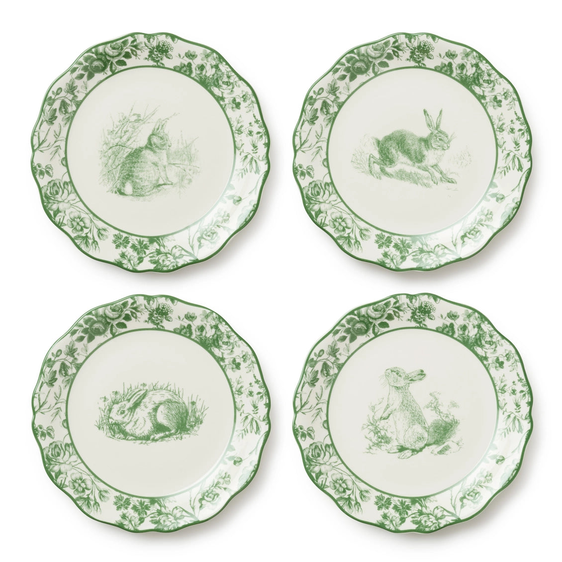 Four decorative plates with green rabbit illustrations on a white background