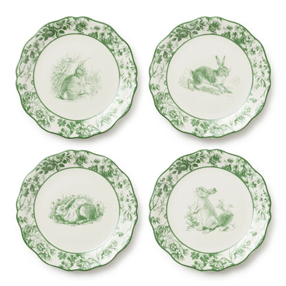 Four decorative plates with green rabbit illustrations on a white background