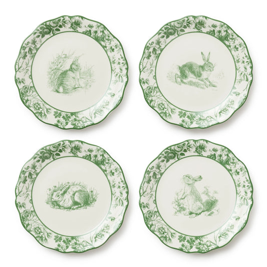 Four decorative plates with green rabbit illustrations on a white background