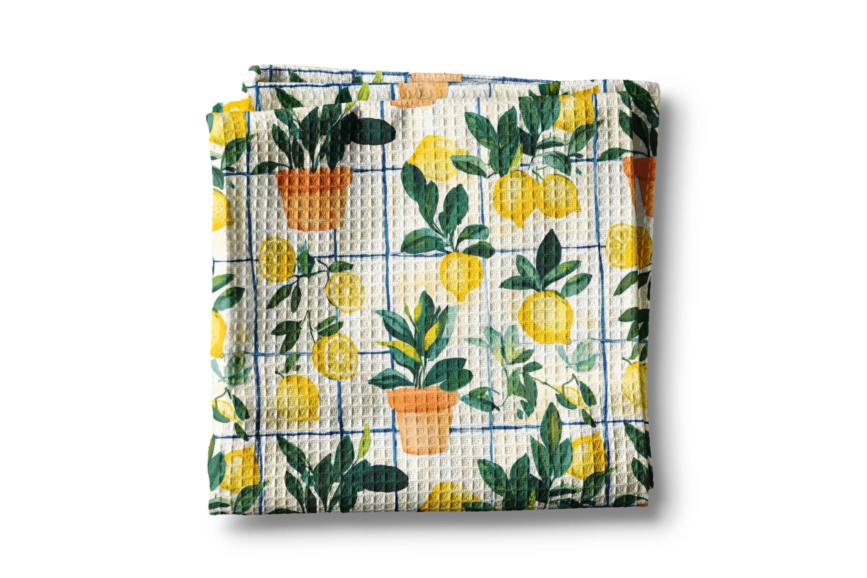 Folded waffle towel with lemon and potted plant pattern on a white background