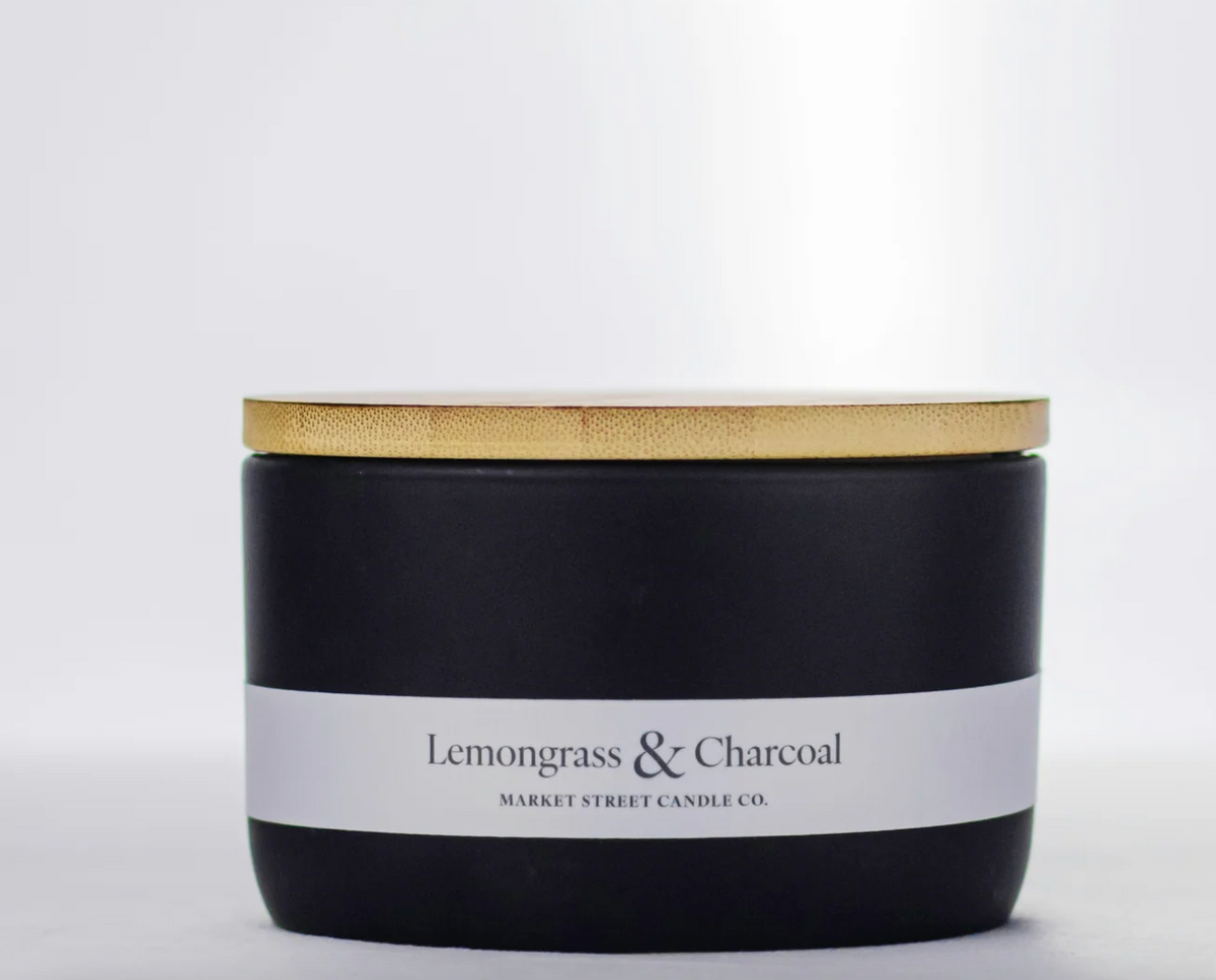 Market Street Candle Co. Lemongrass & Charcoal 16 oz three-wick candle in a black ceramic vessel with gold-tone lid.