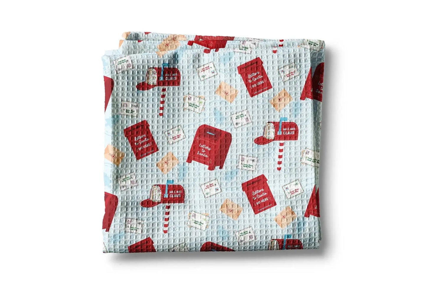 Folded fabric with red book and envelope pattern on a light blue background