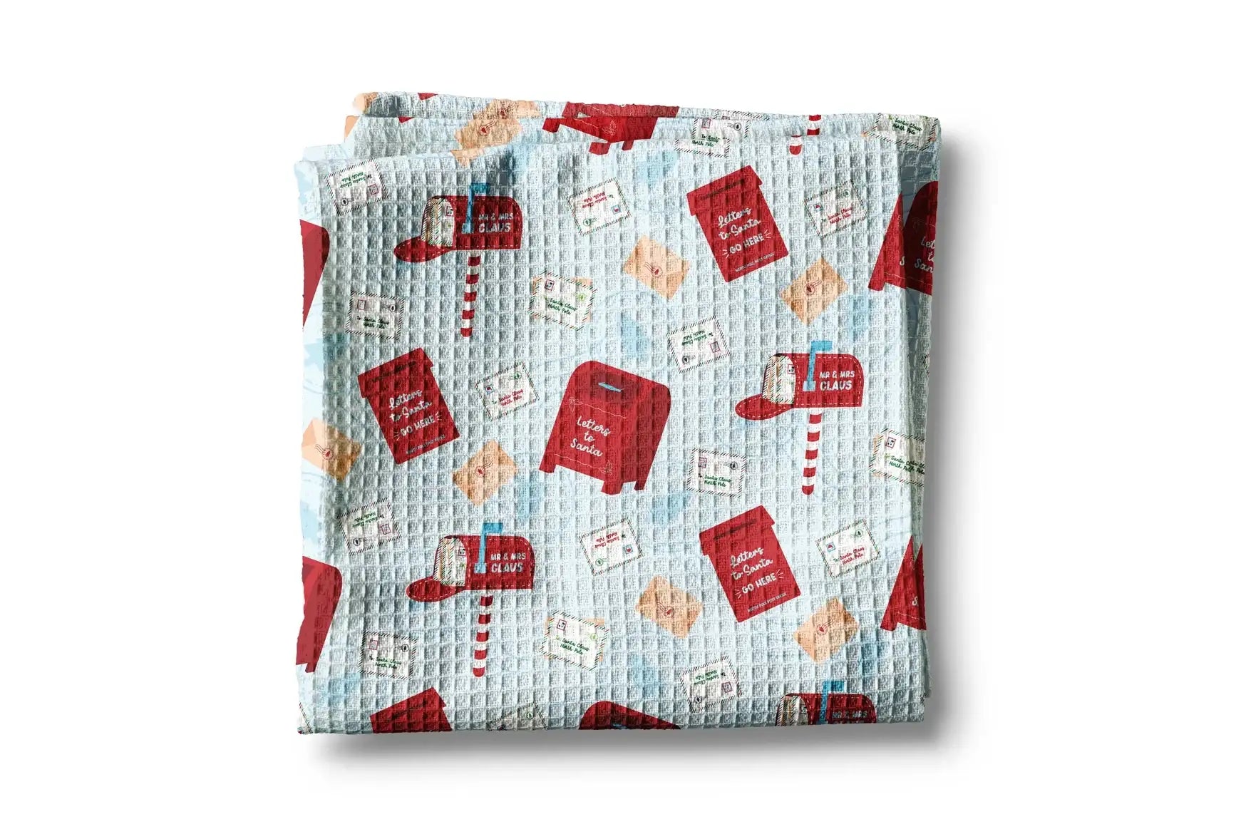 Folded fabric with red book and envelope pattern on a light blue background