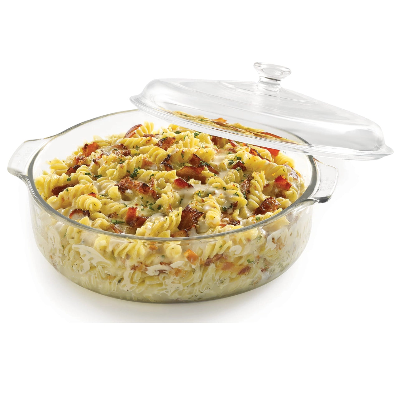 Glass casserole dish with pasta and bacon on a white background