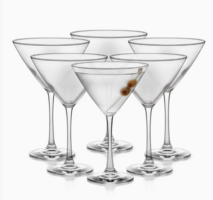 Set of six clear martini glasses on a white background