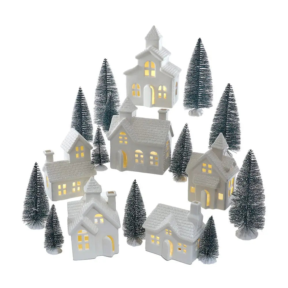Set of small illuminated houses with trees on a white background