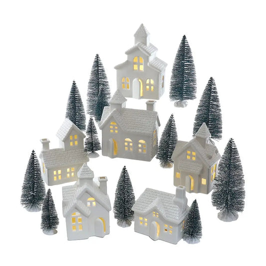 Set of small illuminated houses with trees on a white background